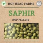 A promotional image for Hop Head Farms featuring "Saphir" hop pellets. Image shows a detailed view of green hop pellets against a cardboard-like background.